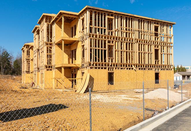 a temporary chain link fence surrounding a job site, requiring strict safety precautions in Maywood, CA